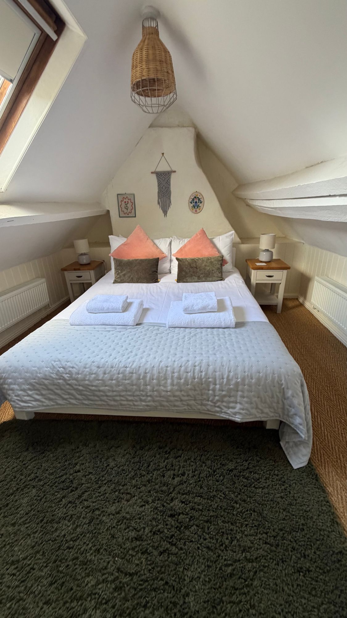 Bedroom three with exposed beam feature wall at Glebe Cottage, Bledington