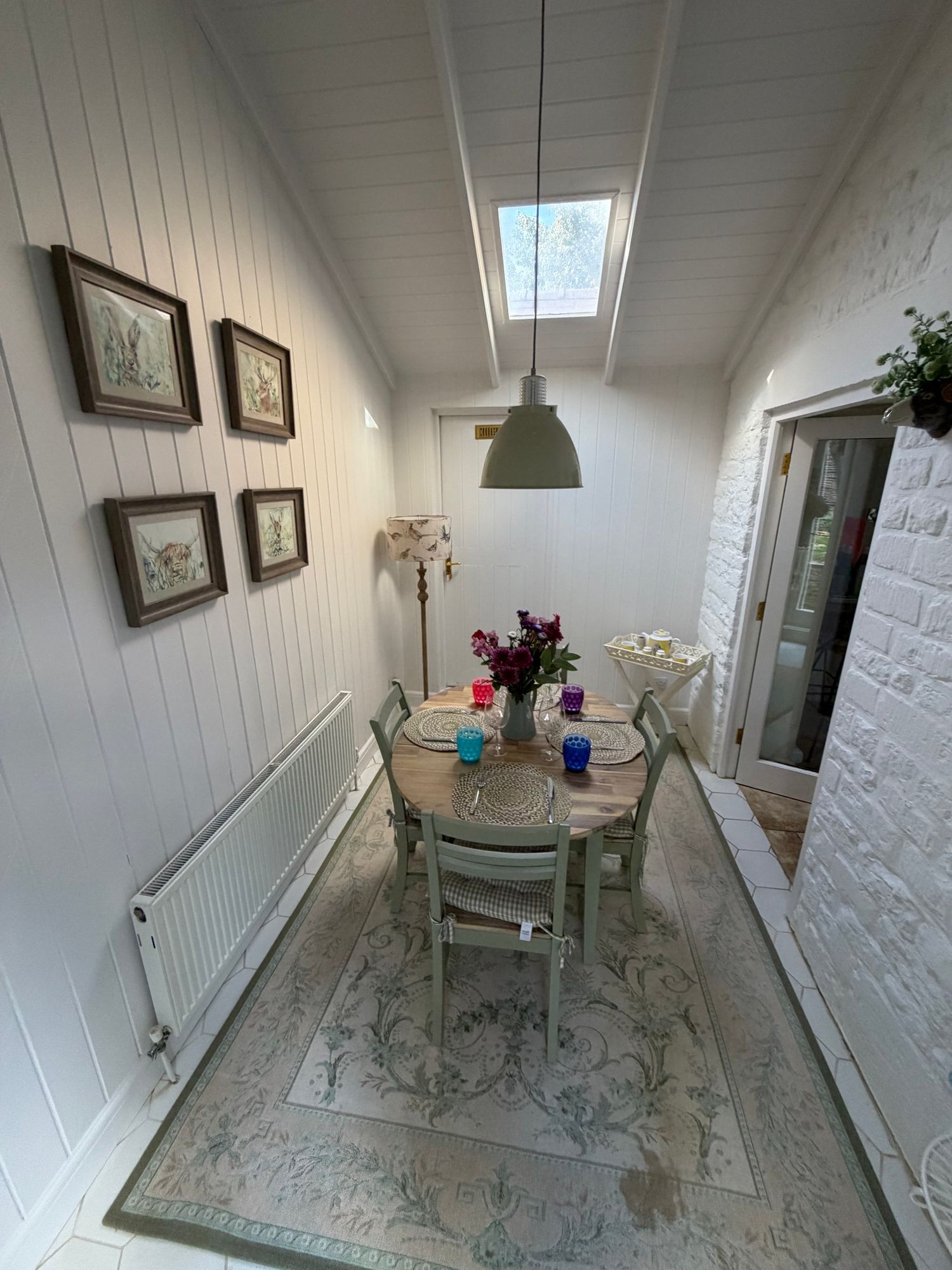 Breakfast room with vaulted ceiling and skylight at Glebe Cottage, Bledington