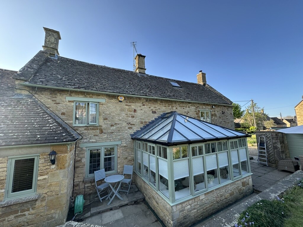Rear conservatory and patio at Glebe Cottage, Bledington, Oxfordshire
