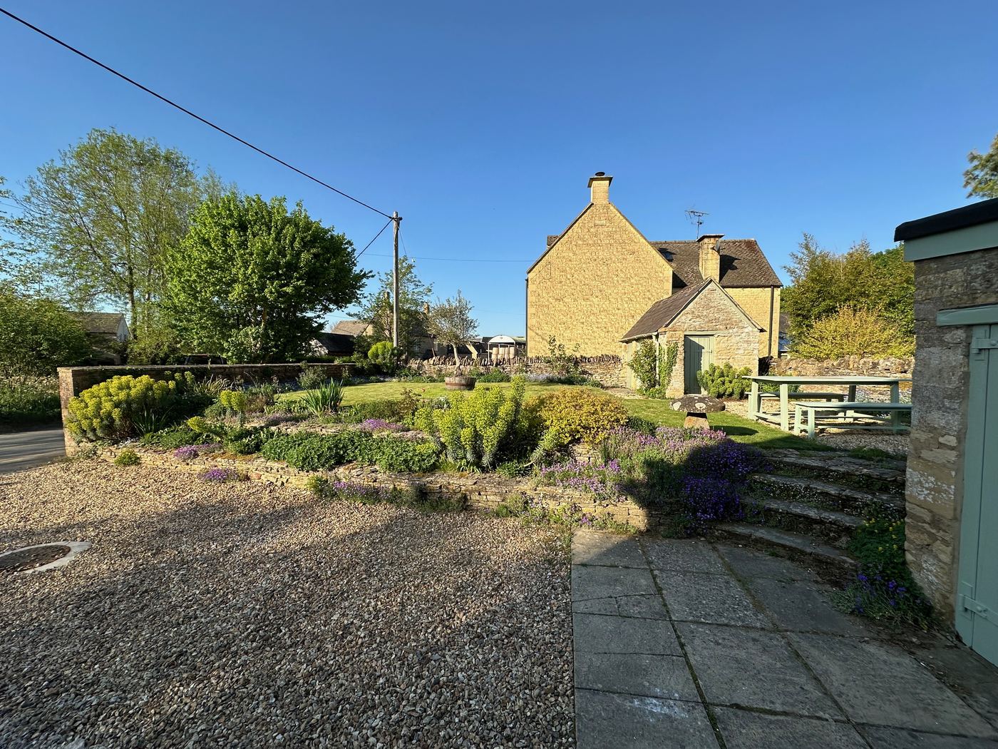 Garden at Glebe Cottage in golden evening light, Bledington